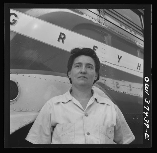 Columbus, Ohio. A woman cleaner who is employed at the Greyhound garage to wash buses