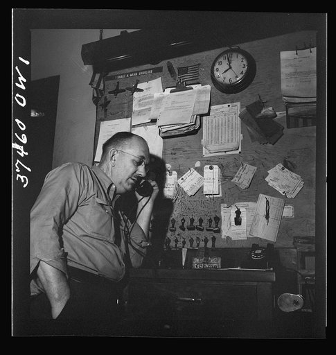 Untitled photo, possibly related to: Cincinnati, Ohio. A baggage clerk in the Greyhound bus terminal