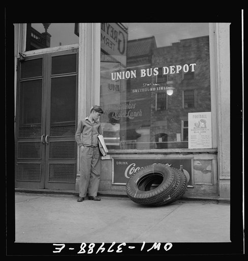 Washington Court House, Ohio. A schoolboy, who rides to and from school daily on a Greyhound bus, waiting outside the depot