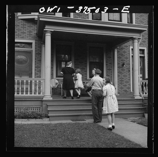 Cincinnati, Ohio. Bernard Cochran, a Greyhound bus driver, going into the house with his family. His wife and children drive down to the terminal to pick him up after work