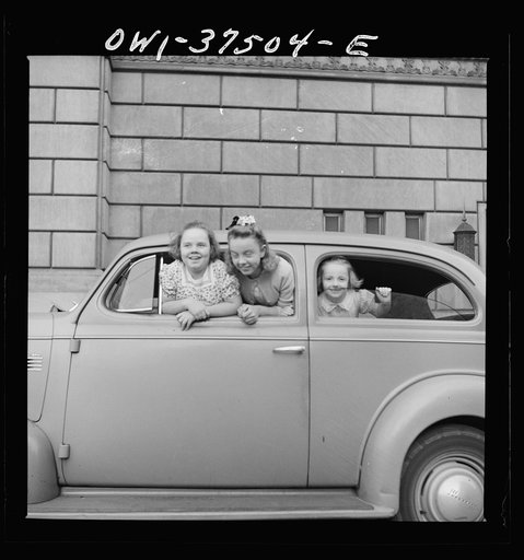 Cincinnati, Ohio. Mary Freda, Irma Jean, and Sue Anne Cochran watching for their father, a Greyhound bus driver, to bring his bus into the terminal