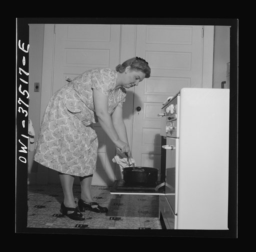 Cincinnati, Ohio. Mrs. Bernard Cochran, wife of a Greyhound bus driver, turning the Sunday roast