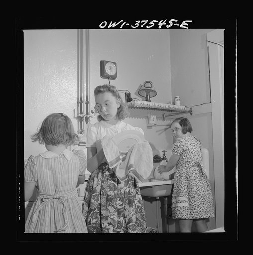Cincinnati, Ohio. The children of Bernard Cochran, a Greyhound bus driver, doing dishes after a Sunday dinner