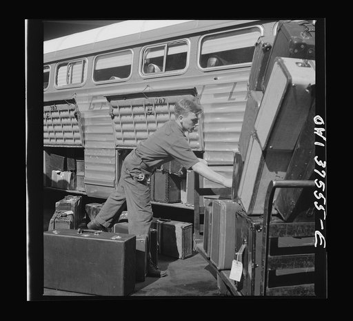 Cincinnati, Ohio. Loading baggage on a Greyhound bus at the bus terminal
