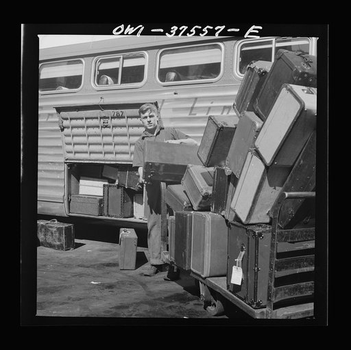 Untitled photo, possibly related to: Cincinnati, Ohio. Loading baggage on a Greyhound bus at the bus terminal