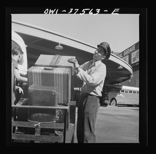Cincinnati, Ohio. Loading baggage on a Greyhound bus at the bus terminal