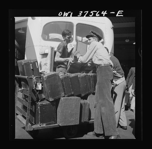Cincinnati, Ohio. Loading baggage on a Greyhound bus at the bus terminal