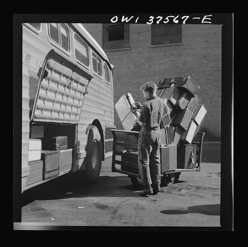 Cincinnati, Ohio. Loading baggage on a Greyhound bus at the bus terminal