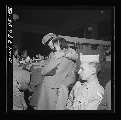 Chicago, Illinois. Private D.N. Danielson, stationed in North Carolina, and Mrs. Danielson, from Minnesota, in the waiting room of the Greyhound bus terminal. They met in Chicago to save time for his furlough