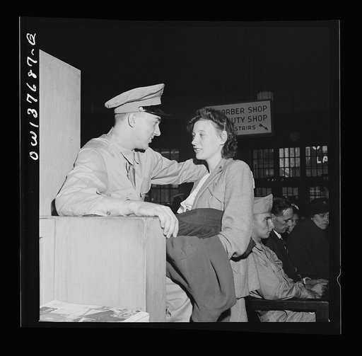 Chicago, Illinois. Private D.N. Danielson, stationed in North Carolina, and Mrs. Danielson, from Minnesota, in the waiting room of the Greyhound bus terminal. They met in Chicago to save time for his furlough