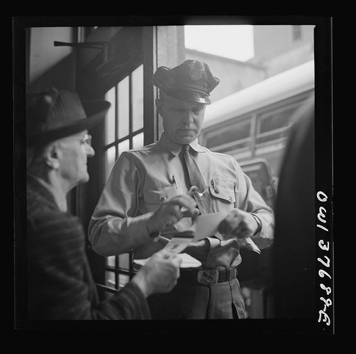 Untitled photo, possibly related to: Chicago, Illinois. A bus driver punching tickets
