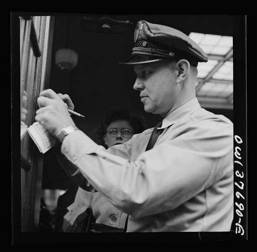 Untitled photo, possibly related to: Chicago, Illinois. A bus driver punching tickets