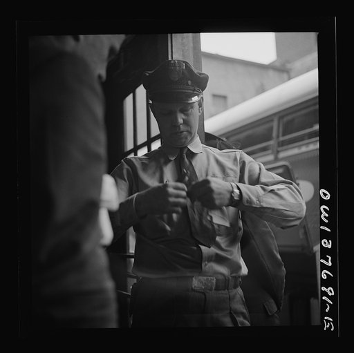 Chicago, Illinois. A bus driver punching tickets