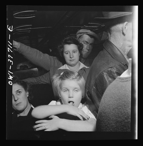 Passengers on a Greyhound bus going from Chicago, Illinois to Cincinnati, Ohio. Most of the standing passengers are local fares going from their farms to town