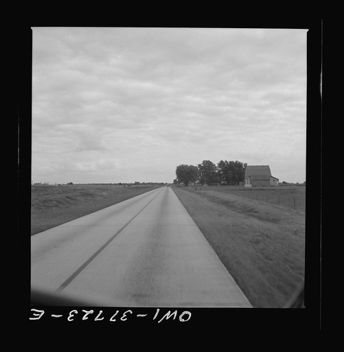 A highway which was formerly crowded with traffic in Indiana as seen from a Greyhound bus