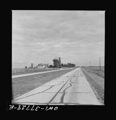 A highway which was formerly crowded with traffic in Indiana as seen from a Greyhound bus