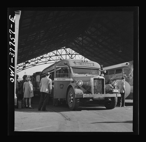 Indianapolis, Indiana. An old-type bus being boarded by passengers in the Greyhound bus terminal. The drivers call this type of bus a "dive bomber." These buses are about ten years old and have been completely rebuilt