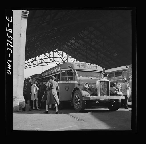 Untitled photo, possibly related to: Indianapolis, Indiana. An old-type bus being boarded by passengers in the Greyhound bus terminal. The drivers call this type of bus a "dive bomber." These buses are about ten years old and have been completely rebuilt