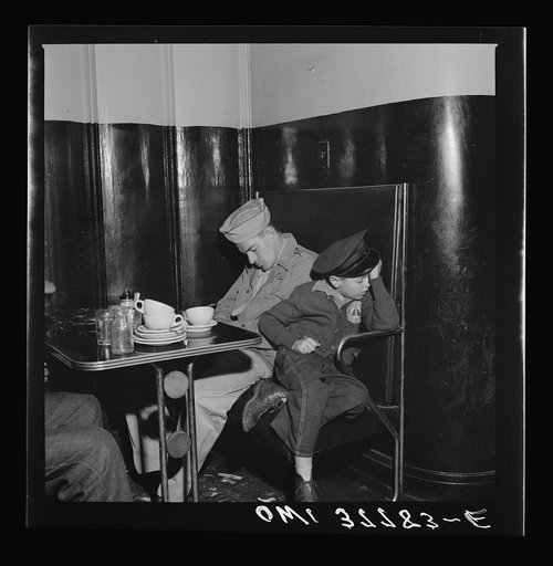 Louisville, Kentucky. Bus passengers sleeping in a booth in the lunchroom of the Greyhound bus terminal at 3 a.m., since all the benches were full