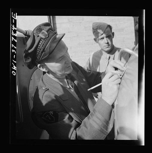 Chicago, Illinois. A bus driver collecting tickets at the Greyhound bus terminal