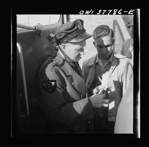 Chicago, Illinois. A bus driver collecting tickets at the Greyhound bus terminal