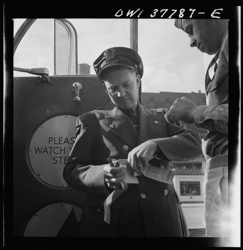 Chicago, Illinois. A bus driver collecting tickets at the Greyhound bus terminal