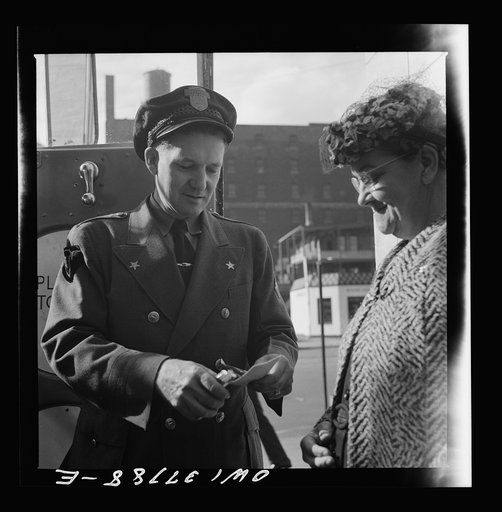 Chicago, Illinois. A bus driver collecting tickets at the Greyhound bus terminal