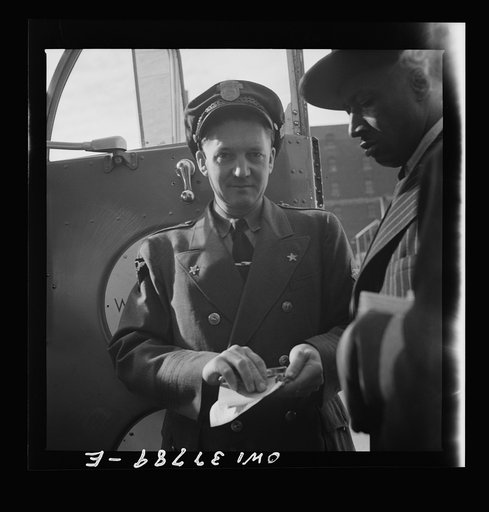 Chicago, Illinois. A bus driver collecting tickets at the Greyhound bus terminal