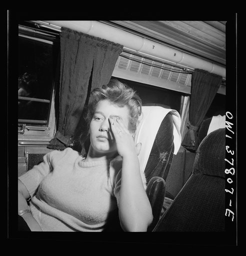 Chicago, Illinois. A girl passenger waking up as the Greyhound bus comes into the city. She came from Knoxville, Tennessee, and is going to Minneapolis to visit a boy in the Army