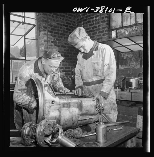 Bus trip from Knoxville, Tennessee, to Washington, D.C. Mechanics at work in the garage of the Tennessee Coach Company at Knoxville