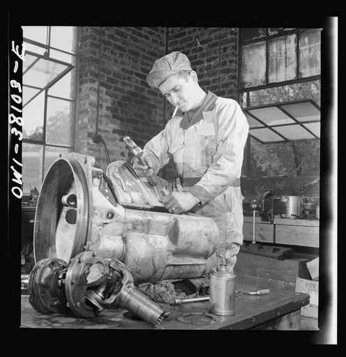 Bus trip from Knoxville, Tennessee, to Washington, D.C. Mechanics at work in the garage of the Tennessee Coach Company at Knoxville