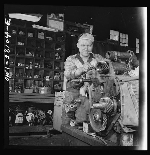 Bus trip from Knoxville, Tennessee, to Washington, D.C. Mechanic rebuilding bus motor at the garage of the Tennessee Coach Company in Knoxville. This is done every 100,000 miles