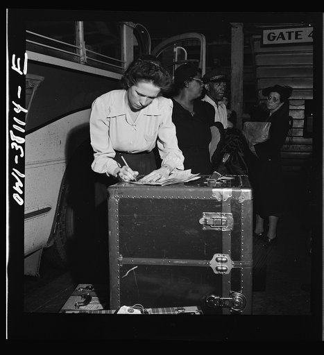 Bus trip from Knoxville, Tennessee, to Washington, D.C. Girl baggage agent checking baggage which has just come off the bus at Knoxville