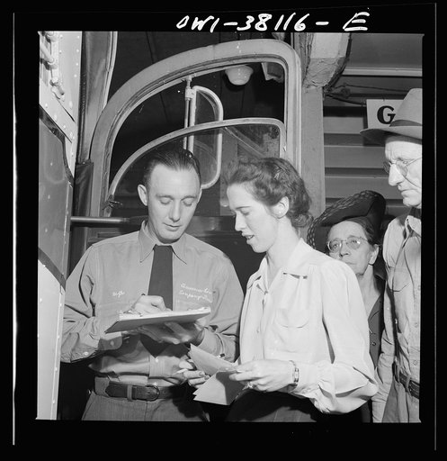 Bus trip from Knoxville, Tennessee, to Washington, D.C. Bus driver signing for manifest baggage which has been loaded on his bus. He is now responsible for it
