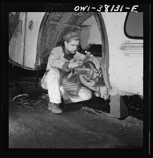 Bus trip from Knoxville, Tennessee, to Washington, D.C. Knoxville, Tennessee. A mechanic working on a brake lining at the garage of the Tennessee Coach Company