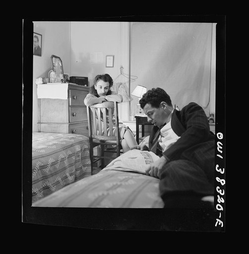 Washington, D.C. Reading the newspaper aloud in a boardinghouse room
