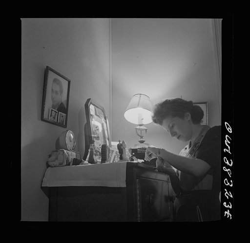 Washington, D.C. This girl met her husband at the boardinghouse. When he was drafted, she moved back into her old room. His pictures decorate the dresser and wall