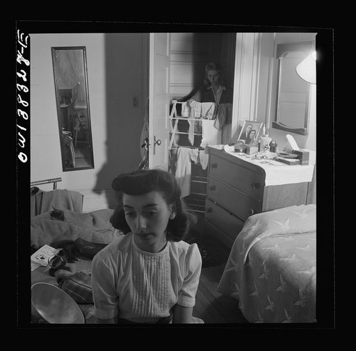 Washington, D.C. Girl in the doorway of her room at a boardinghouse