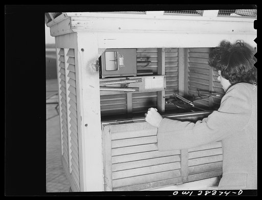 Washington, D.C. The U.S. Weather Bureau station at the National Airport. Surface temperature readings being recorded by an observer at a Weather Bureau instrument shelter