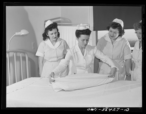 Washington, D.C. High school students who work as nurse's aides at emergency hospital learning to make a bed according to hospital standards
