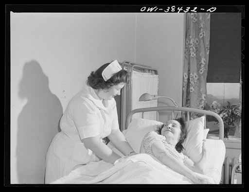 Washington, D.C. Eleanor Jefferis, a student at Woodrow Wilson High School who is a nurse's aide, giving an alcohol rub to a patient at emergency hospital