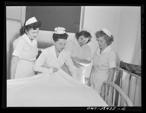 Washington, D.C. High school students who work as nurse's aides at emergency hospital learning to make a bed according to hospital standards