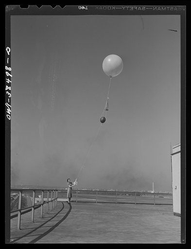 Washington, D.C. The U.S. Weather Bureau station at the National Airport. Atmospheric conditions are transmitted by a weather radio instrument attached to the balloon which ascends to heights of fifteen to twenty miles