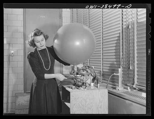 Washington, D.C. The U.S. Weather Bureau station at the National Airport. Inflating a pilot balloon with hellium gas. The balloon is used for determining winds aloft