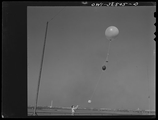 Washington, D.C. The U.S. Weather Bureau station at the National Airport. This high frequency radio transmitter is small, but very effective. It is attached to a large balloon and transmitts signals which reveal temperature, humidity and pressure