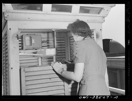 Washington, D.C. The U.S. Weather Bureau station at the National Airport. Surface temperature readings being recorded by an observer at a Weather Bureau instrument shelter