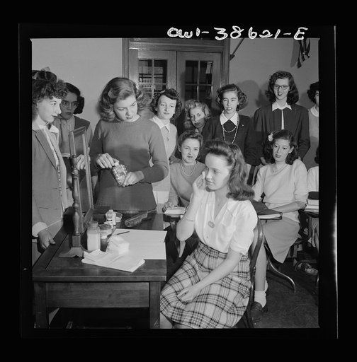 Washington, D.C. A demonstration of the correct procedure in applying street makeup in a home management class at Woodrow Wilson High School