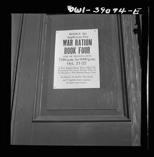 Untitled photo, possibly related to: A sign in front of Woodrow Wilson High School on the day when number four ration books were issued