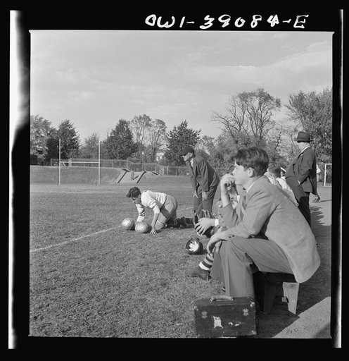 Washington, D.C. Woodrow Wilson High School manager watching a football game from the sidelines