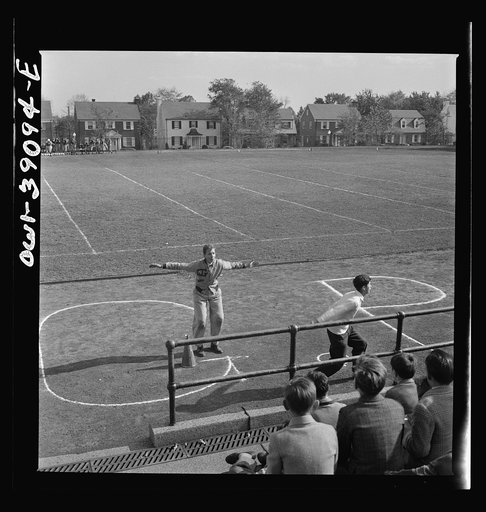 Washington, D.C. Georgetown Preparatory School cheerleader in action. His team is opposing that of Woodrow Wilson High School